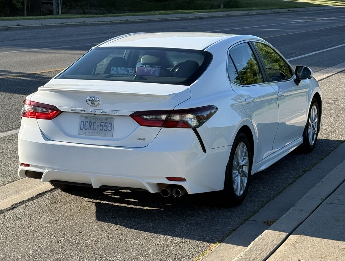 White Toyota Camry rear and side exterior view